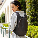 Model wearing the ARSAYO Mela backpack in dark brown AppleSkin