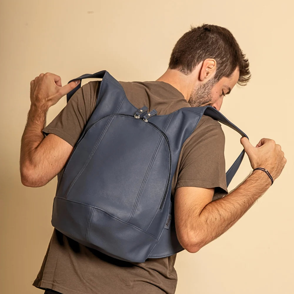 Model wearing the ARSAYO Mela backpack in storm blue AppleSkin