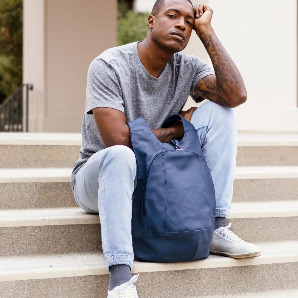 Model wearing the ARSAYO Mela backpack in storm blue AppleSkin