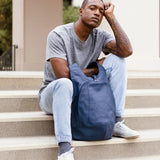 Model wearing the ARSAYO Mela backpack in storm blue AppleSkin