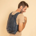 Model wearing the ARSAYO Original vegan backpack in dark blue