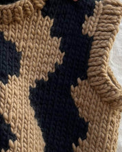 Close-up of Brown wool vest by Atelier 8|02, showcasing hand-knitted black waves
