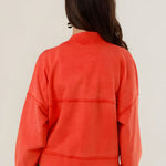 Rear view of the Azellia red acid-washed jacket on a model, showcasing its loose slouchy fit and back panel stitching details.