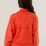 Rear view of the Azellia red acid-washed jacket on a model, showcasing its loose slouchy fit and back panel stitching details.