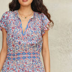 Elevated artisan cotton maxi dress by Mabe Apparel featuring pink and blue summer floral patterns.