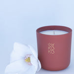 BYKOKO Peony Romance scented candle styled with a white flower