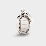 Coluri Talisman charm with a snow-white stone in silver, back view