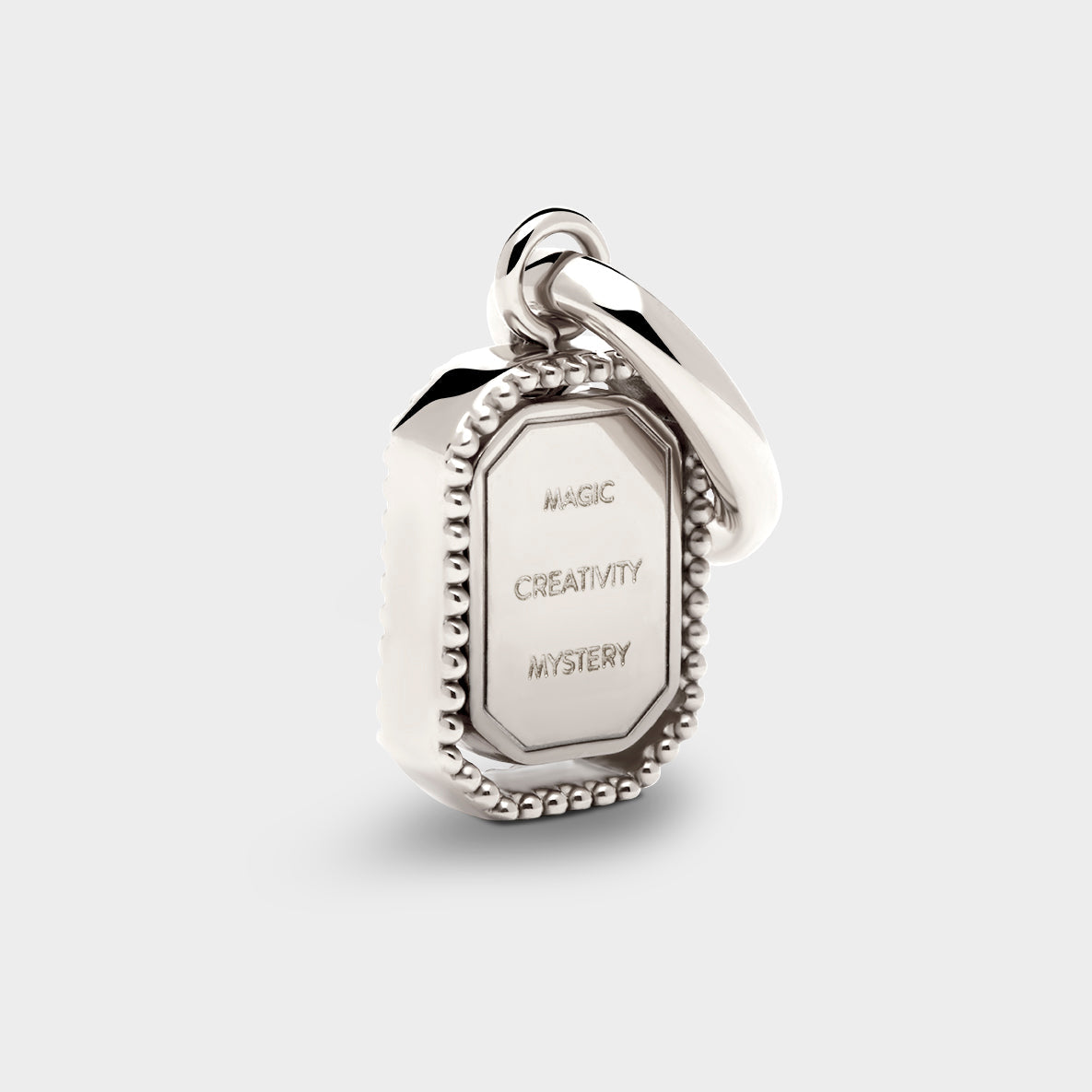 Coluri Talisman charm with a violet stone in silver, back view