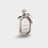 Coluri Talisman charm with a violet stone in silver, back view