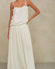 Model wearing the Mabe Apparel cream tiered maxi skirt paired with a white strappy cotton top.
