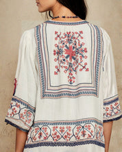 Close-up view of the detailed geometric back embroidery on a Mabe Apparel ecru jacket.