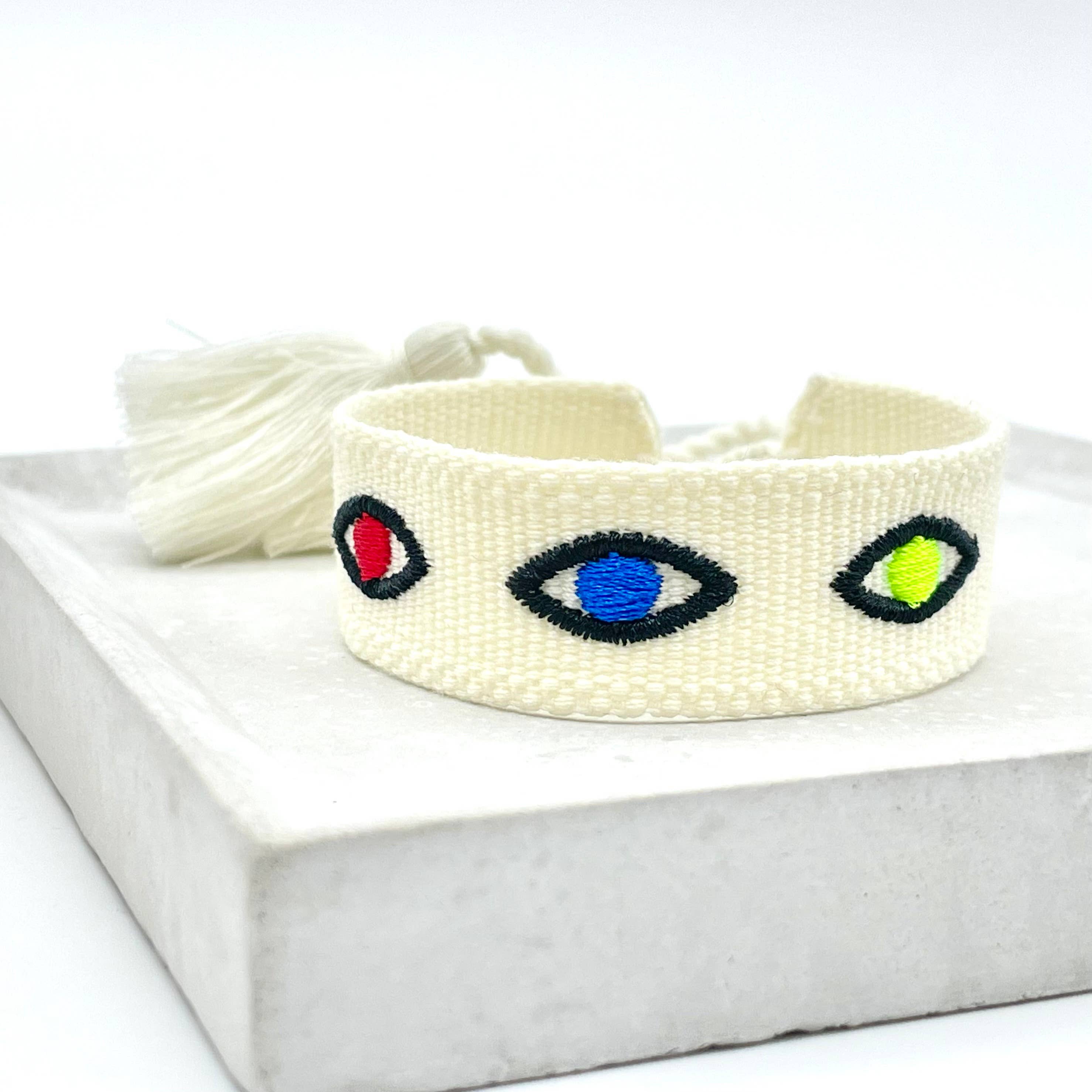 Ecru Nazar Boncuk Evil Eye Bracelet with vibrant Mati embroidery and tassels.