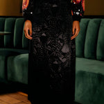 Front view focal shot showcasing the elegant drape, fluid movement, and subtle leopard texture of the FARM Rio black jacquard maxi skirt.