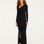 Full-length look: FARM Rio black rosette jersey blouse styled with a black maxi skirt and ankle boots