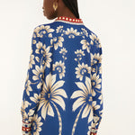 Back view of a model in a studio showcasing the continuous lunar and botanical pattern design on the FARM Rio pajama shirt.