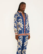 Side view of a model in a studio showcasing the relaxed, airy silhouette of the Farm Rio blue patterned pajama shirt.