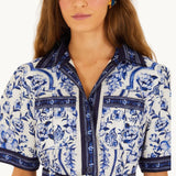 Close-up detail of the FARM Rio Blue Porcelain Garden dress showing the collar, button placket and matching belt with circular buckle