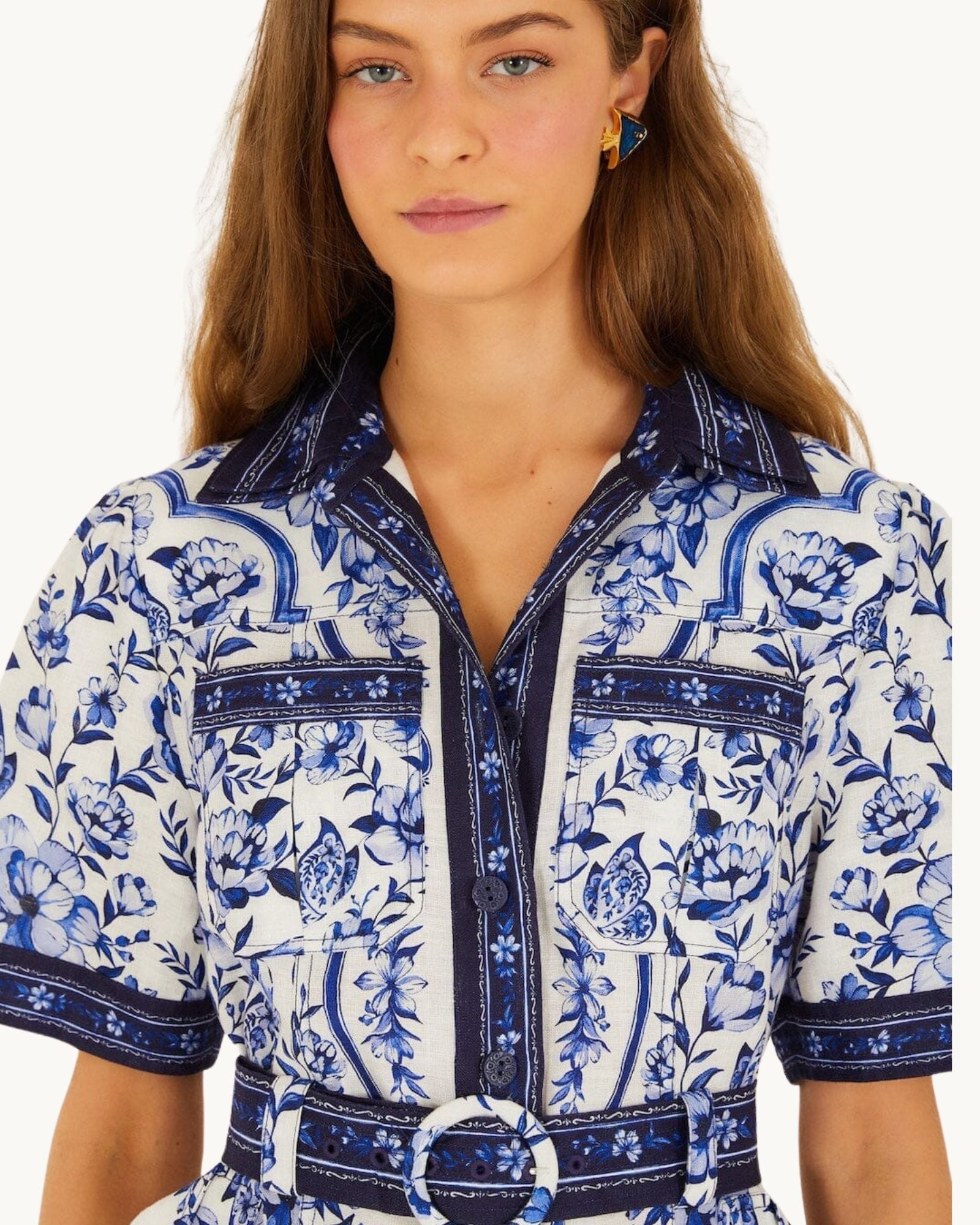 Close-up detail of the FARM Rio Blue Porcelain Garden dress showing the collar, button placket and matching belt with circular buckle