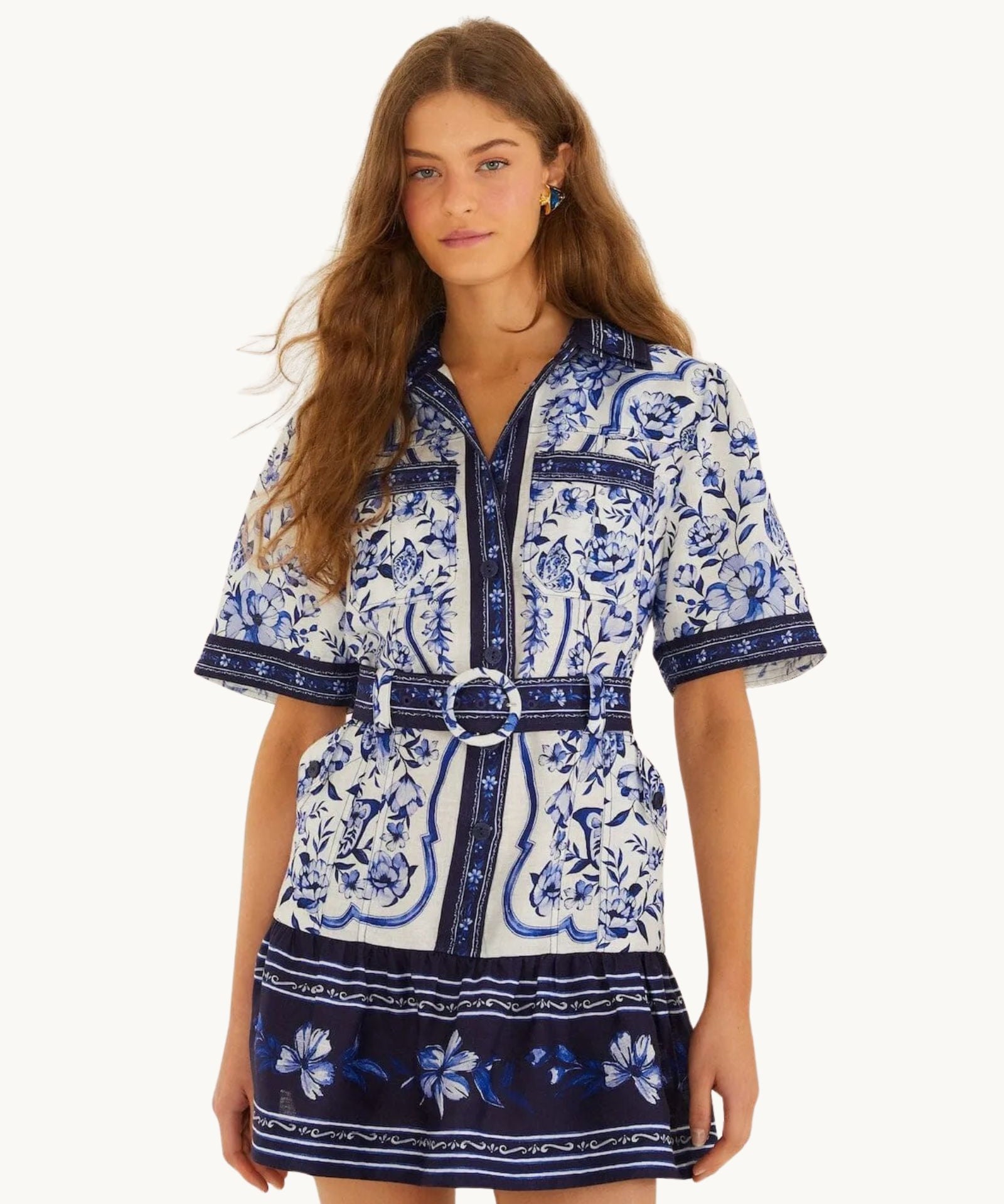 Front view of the FARM Rio Blue Porcelain Garden linen mini shirt dress with matching circular-buckle belt and blue Azulejo tile print