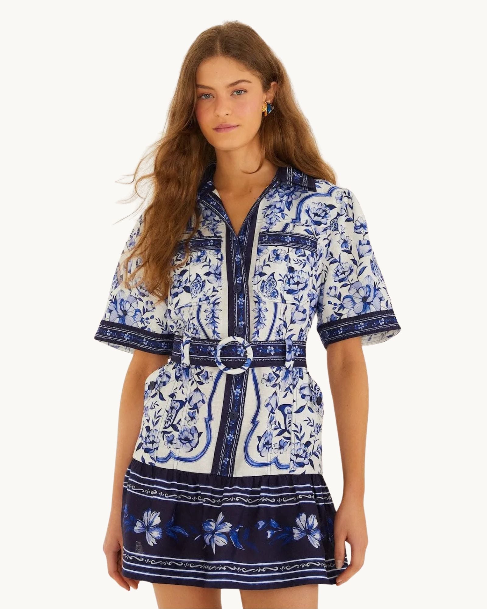 Front view of the FARM Rio Blue Porcelain Garden linen mini shirt dress with matching circular-buckle belt and blue Azulejo tile print