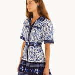 Side view of the FARM Rio Blue Porcelain Garden mini shirt dress showing the relaxed short sleeves and belted waist
