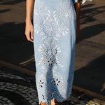 Close-up view of the intricate Richelieu embroidery and scalloped wavy hem on the Farm Rio denim midi skirt.
