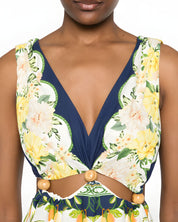 Close-up shot of the Farm Rio midi dress, focusing on the plunging V-neckline, side waist cut-outs, and distinct embellished tassel details.