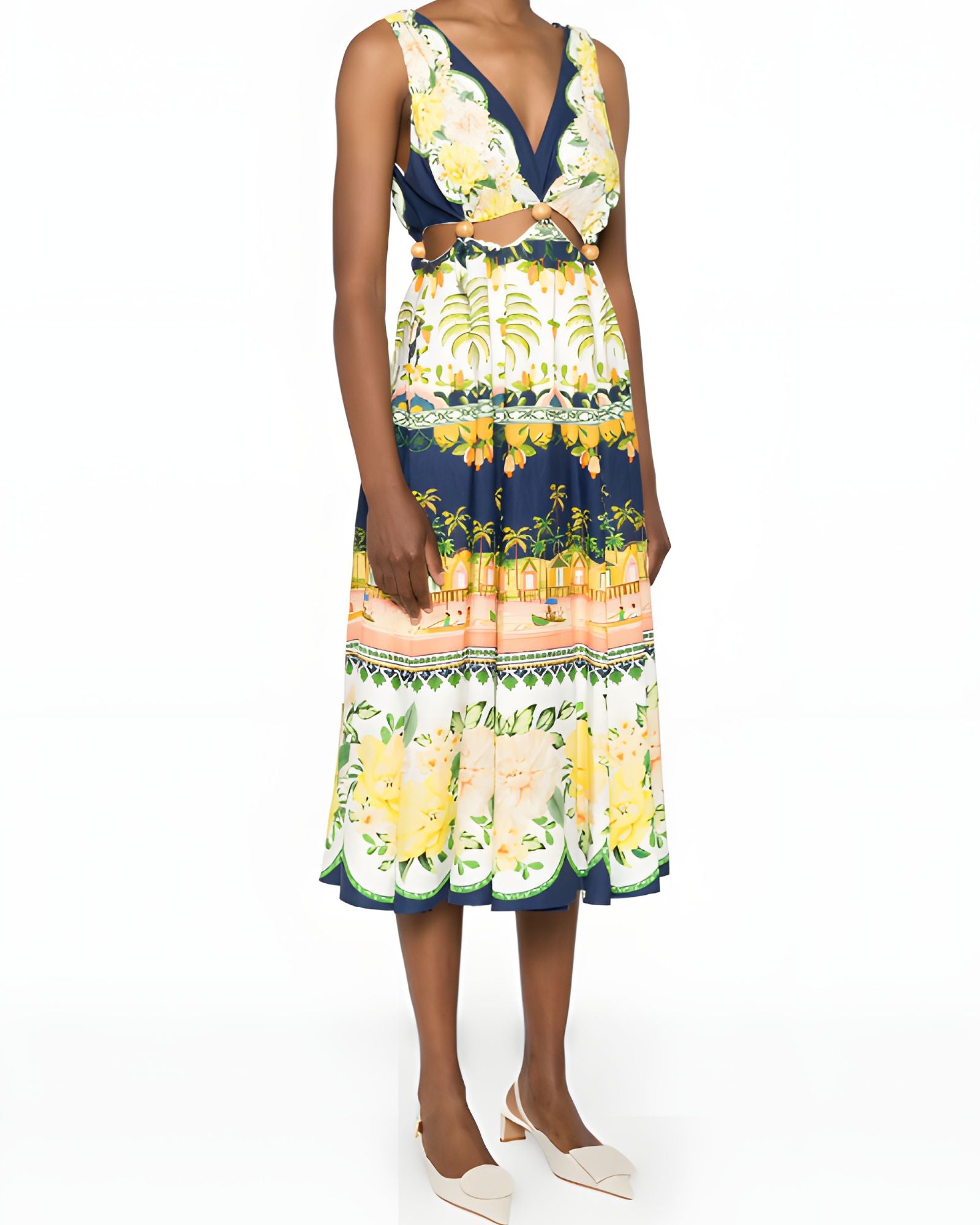 Slight side-angle view of a model in the Farm Rio embellished cutout midi dress, displaying the flowing skirt and delicate hanging drawstring ties.