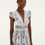 Model wearing the Farm Rio Flowers Arch ruffled mini dress