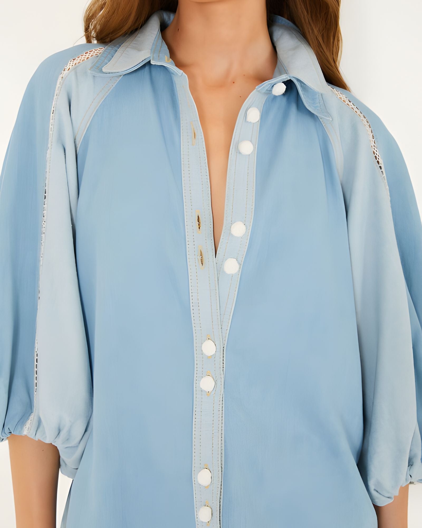 Close-up view of the FARM Rio bicolor blue denim blouse, focusing on the soft collar, distinct white crochet buttons, and open-knit lace inserts at the shoulders.