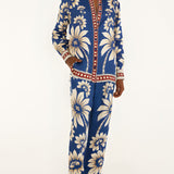 Full-length front view of a model wearing the FARM Rio Blue Luna pajama pants with a relaxed wide-leg cut and botanical print.