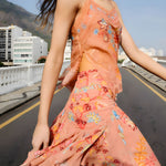 Side view of a model styling the sleeveless mocha FARM Rio lace blouse.