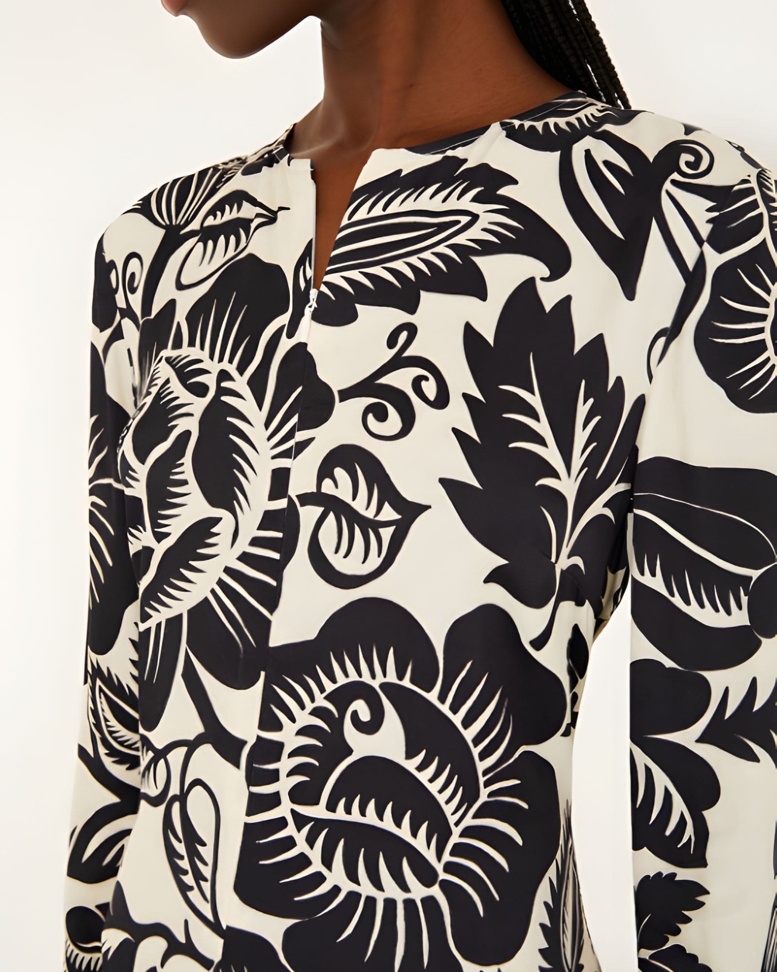 Close-up view of the Farm Rio Off-White Cashews and Birds maxi dress, highlighting the detailed slit V-neckline and artistic contrast print.