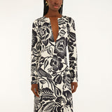 Front view of a model highlighting the sleek column silhouette and sophisticated deep V-neckline slit of the Farm Rio printed maxi dress.