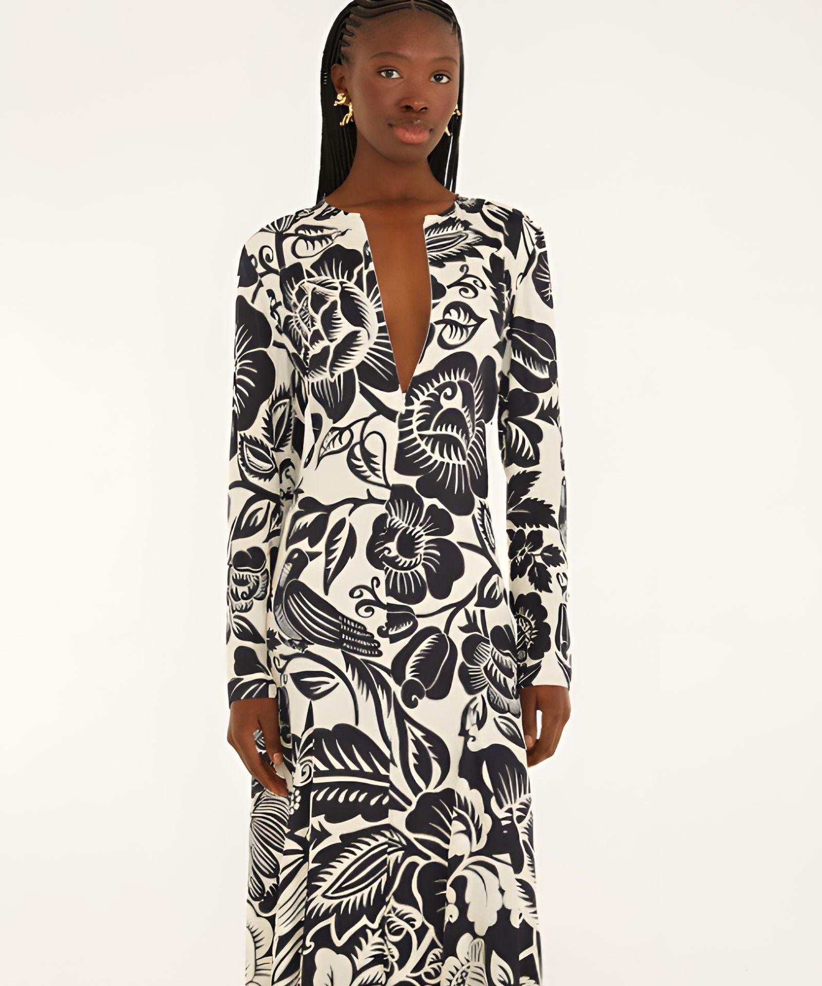 Front view of a model highlighting the sleek column silhouette and sophisticated deep V-neckline slit of the Farm Rio printed maxi dress.