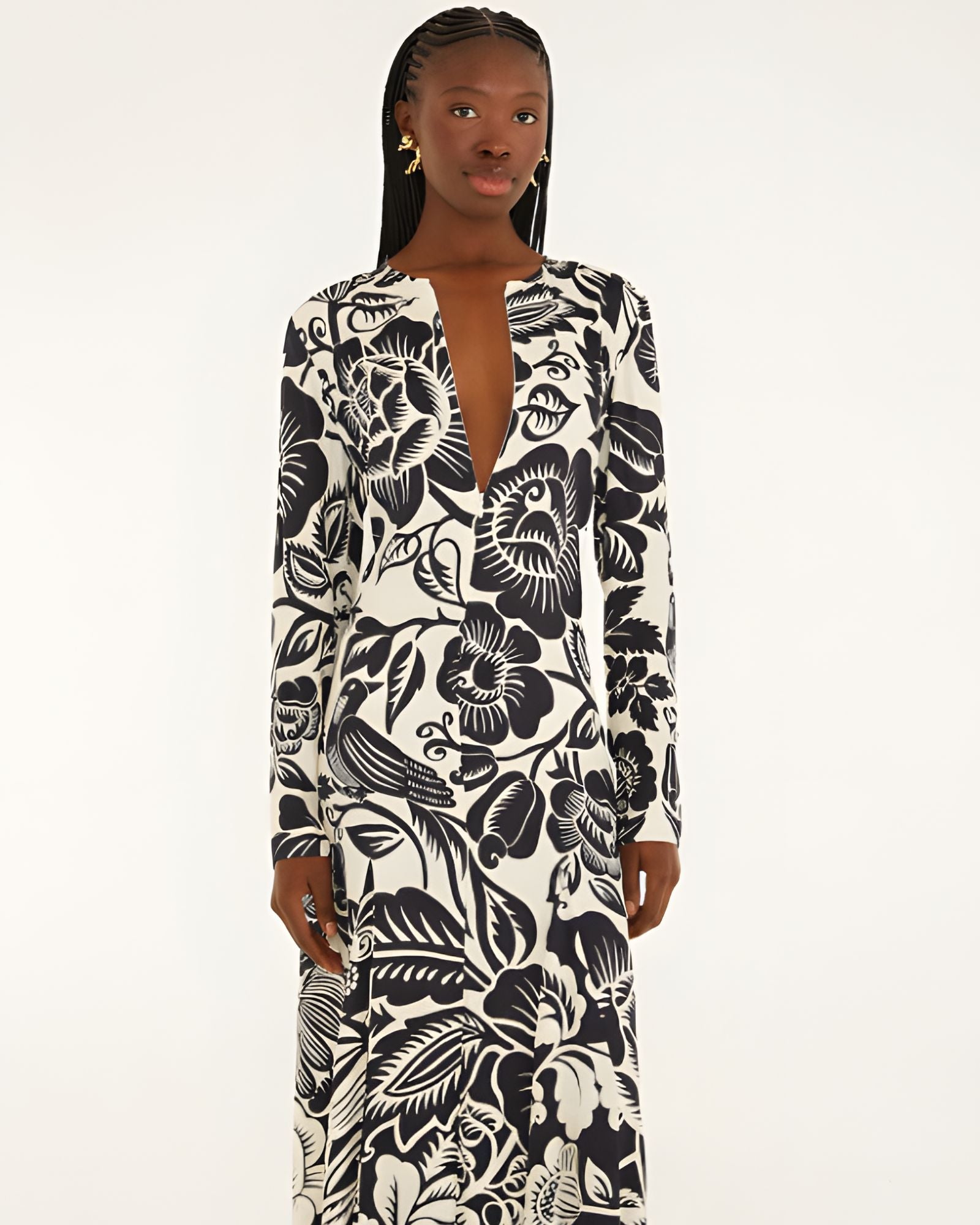Front view of a model highlighting the sleek column silhouette and sophisticated deep V-neckline slit of the Farm Rio printed maxi dress.