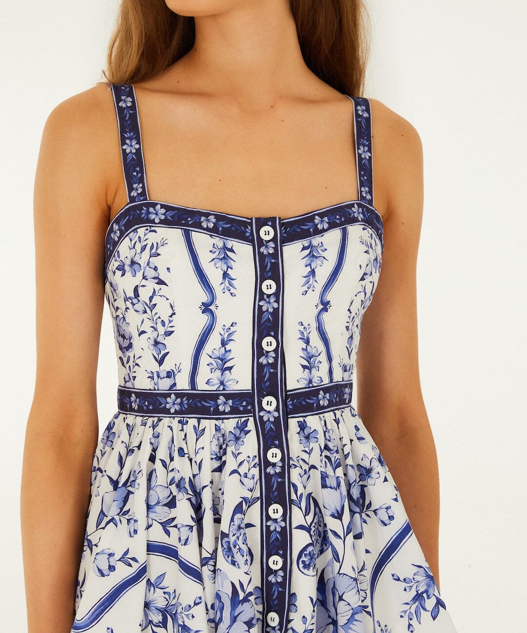 Detailed view of the hand-painted floral print and buttoned front on the FARM Rio Porcelain Garden mini dress