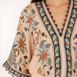 Close-up view of the V-neckline, lace trim, and floral print on the Farm Rio kimono sleeve bodysuit.