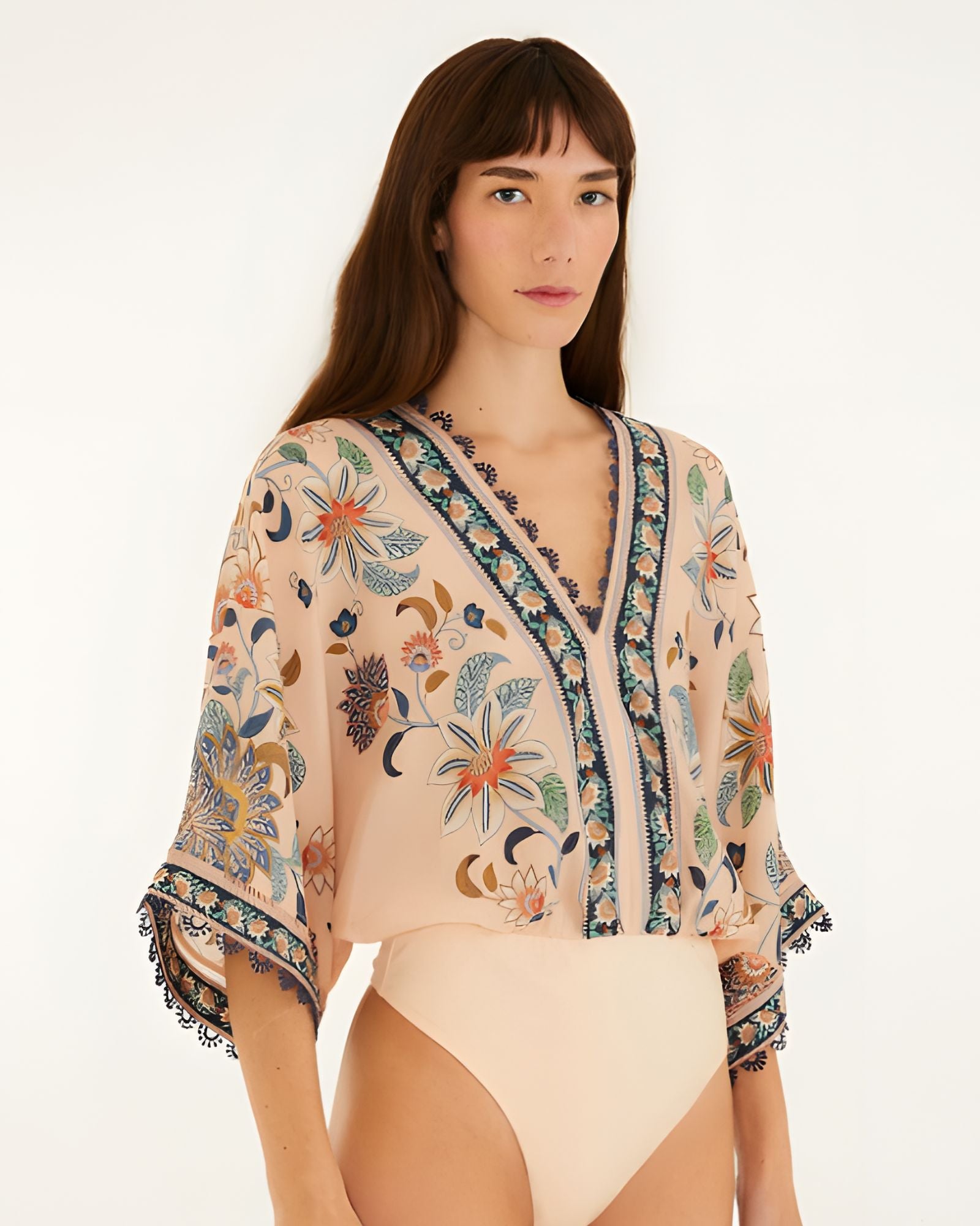 Studio view of the Farm Rio soft pink floral bodysuit highlighting the fit and bottom cut.