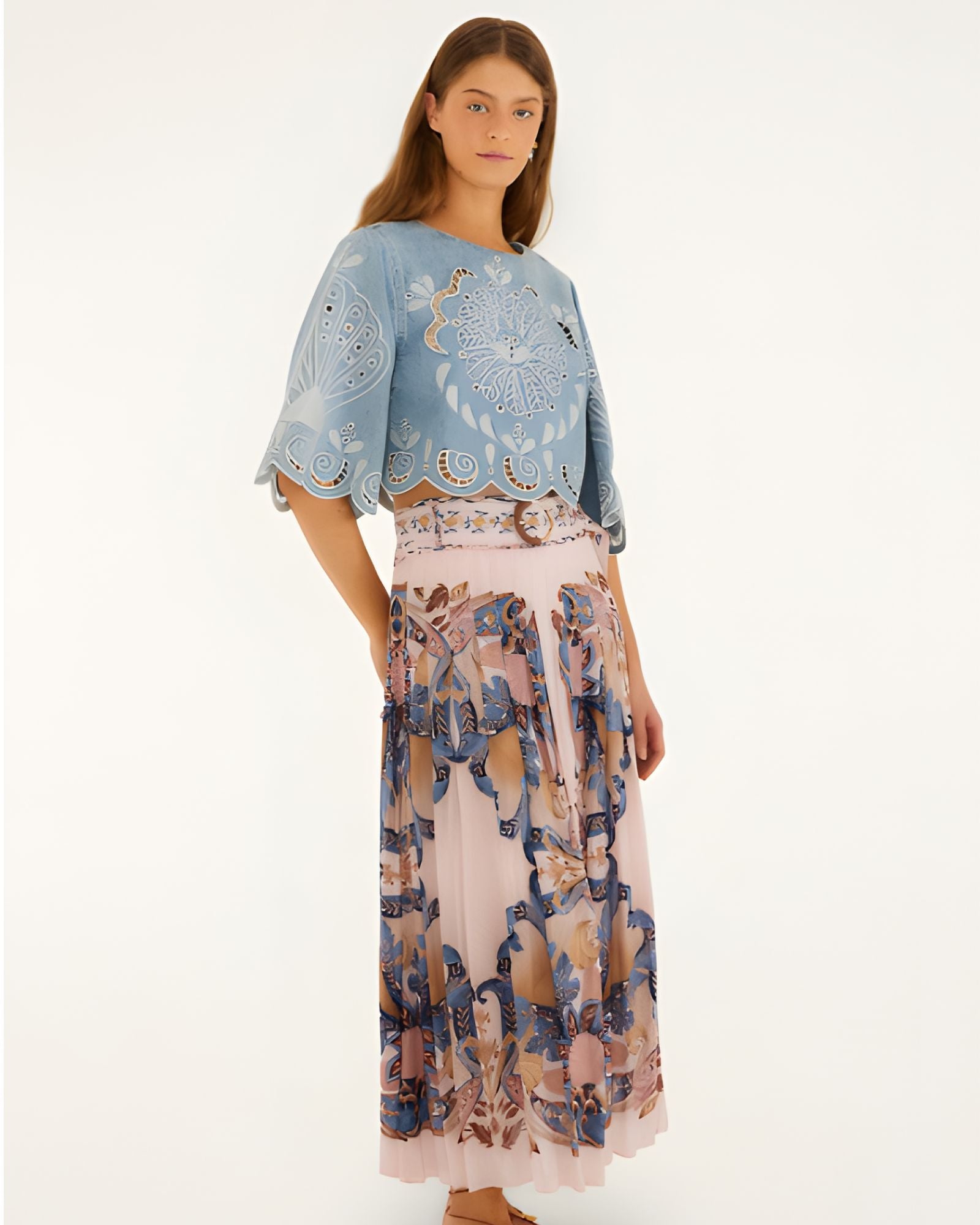 Full body view of a model styling the soft pink Farm Rio pleated maxi skirt with a blue top