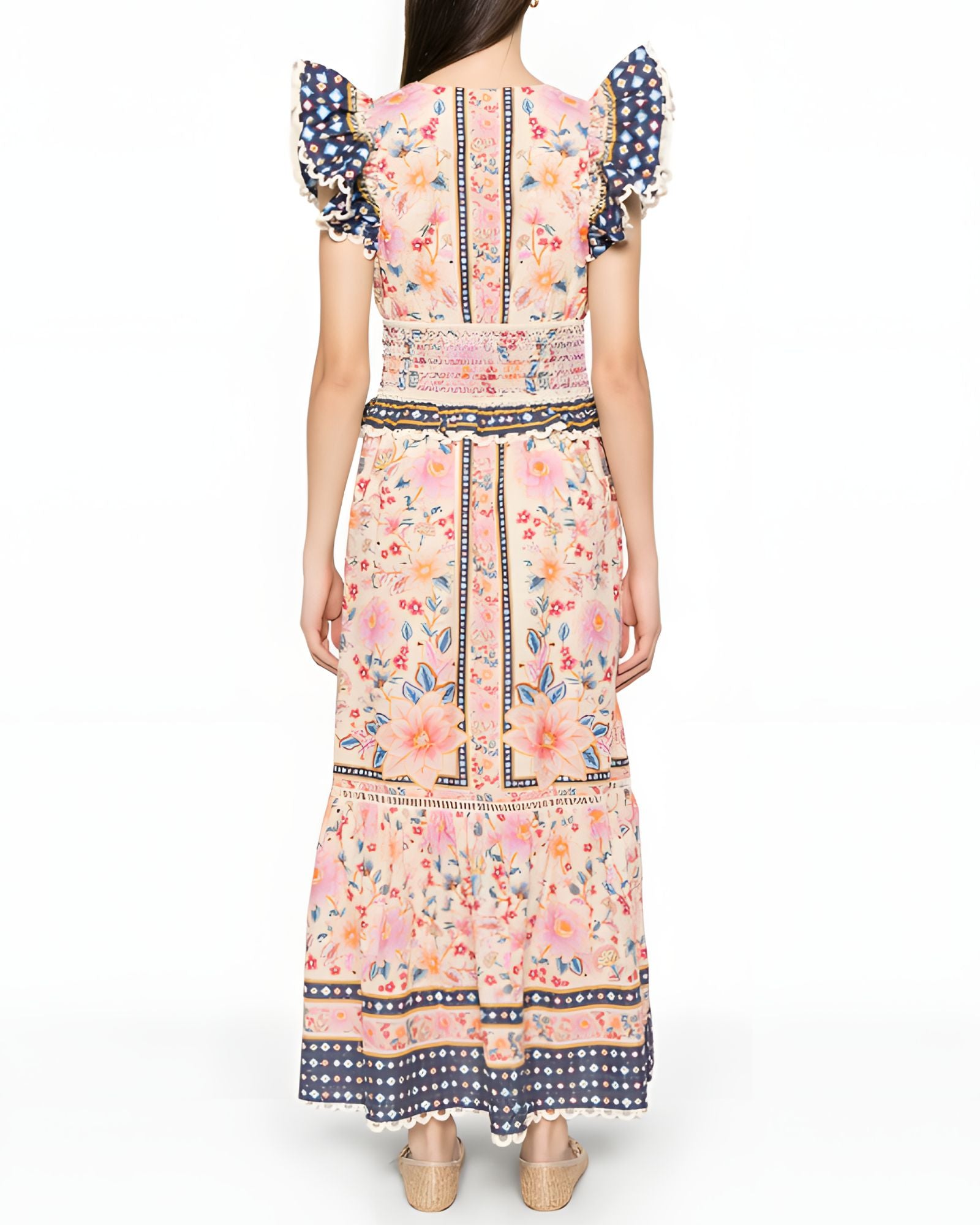 Full-length back studio view of the Farm Rio maxi dress, highlighting the continuous floral pattern, smocked waist detailing, and ruffled shoulders.