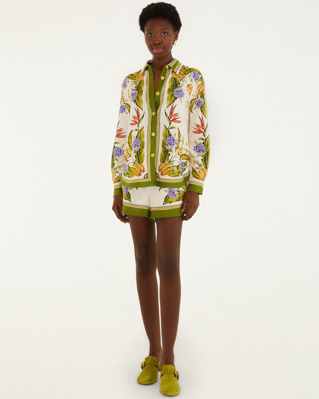 Person wearing a colorful floral-patterned outfit on a white background
