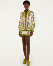Person wearing a colorful floral-patterned outfit on a white background