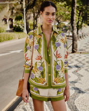 Woman wearing a floral patterned summer outfit by Farm Rio.