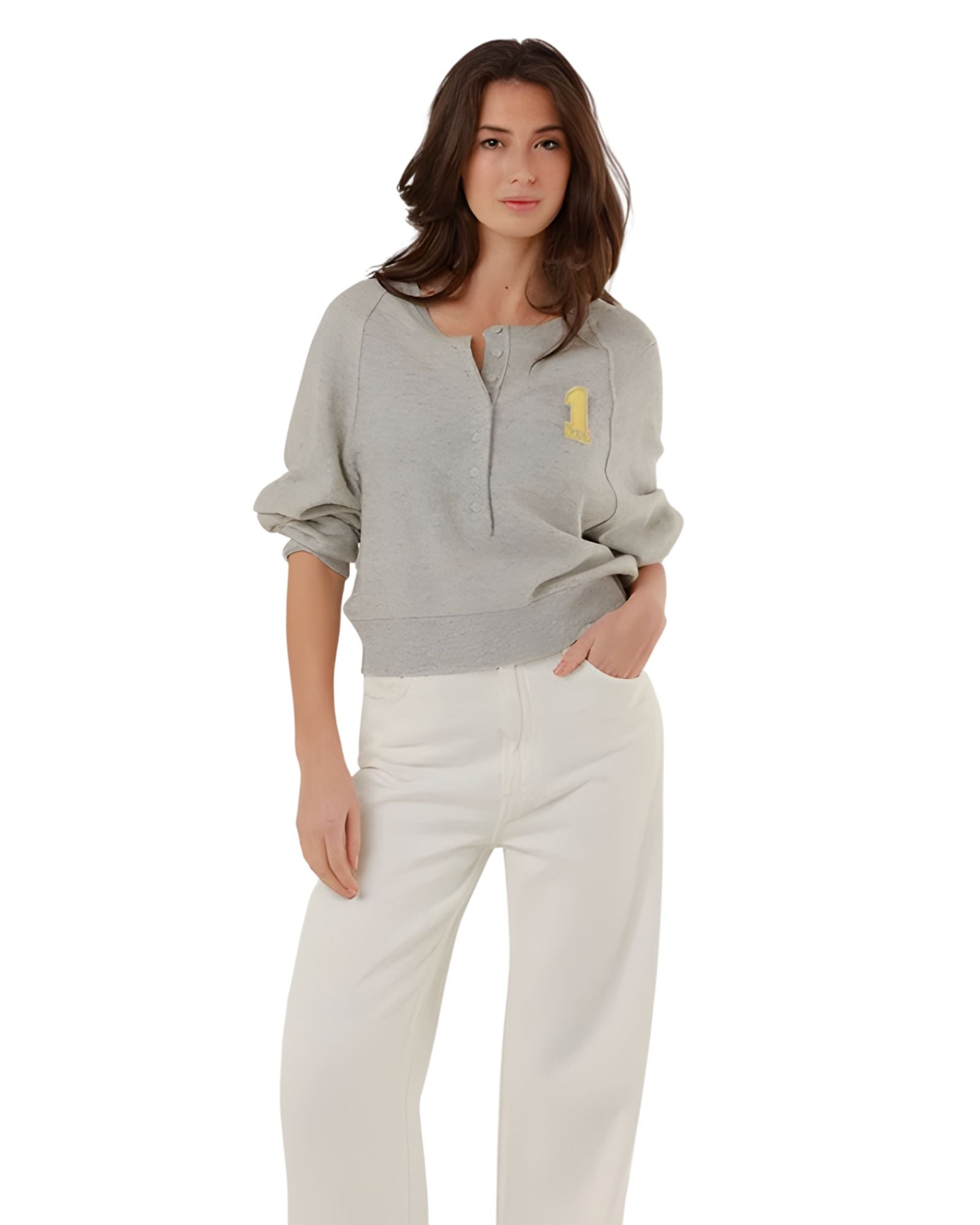 Full-length front view of a model styling the grey fine knit pullover with high-waisted white denim trousers.