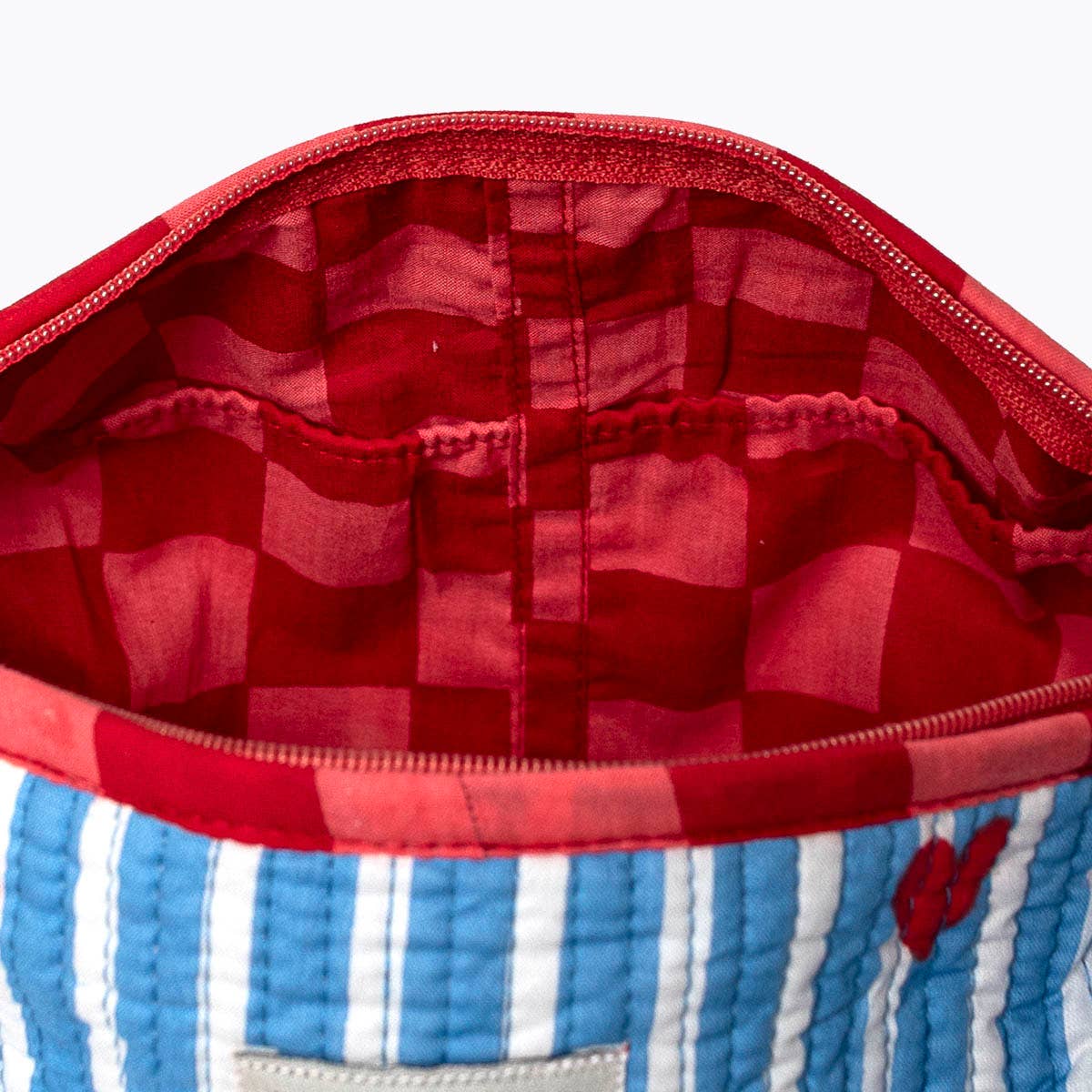 KIKOONI Love Edition blue cosmetic bag, open to show the red printed lining