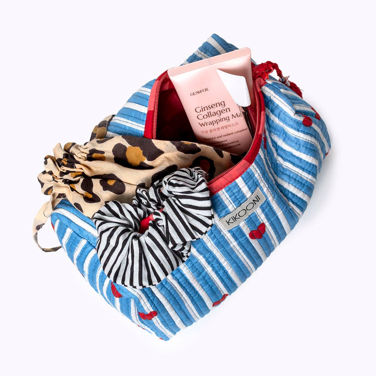 KIKOONI Love Edition blue cosmetic bag, open and packed with a scarf and essentials