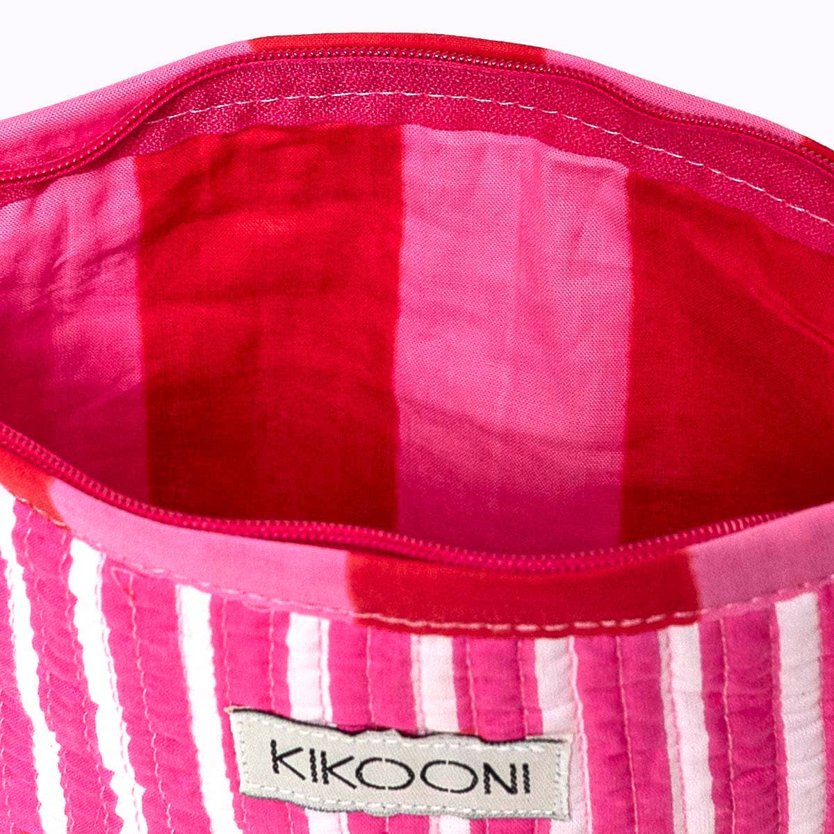 KIKOONI Love Edition pink mini pouch, open to show the red printed lining