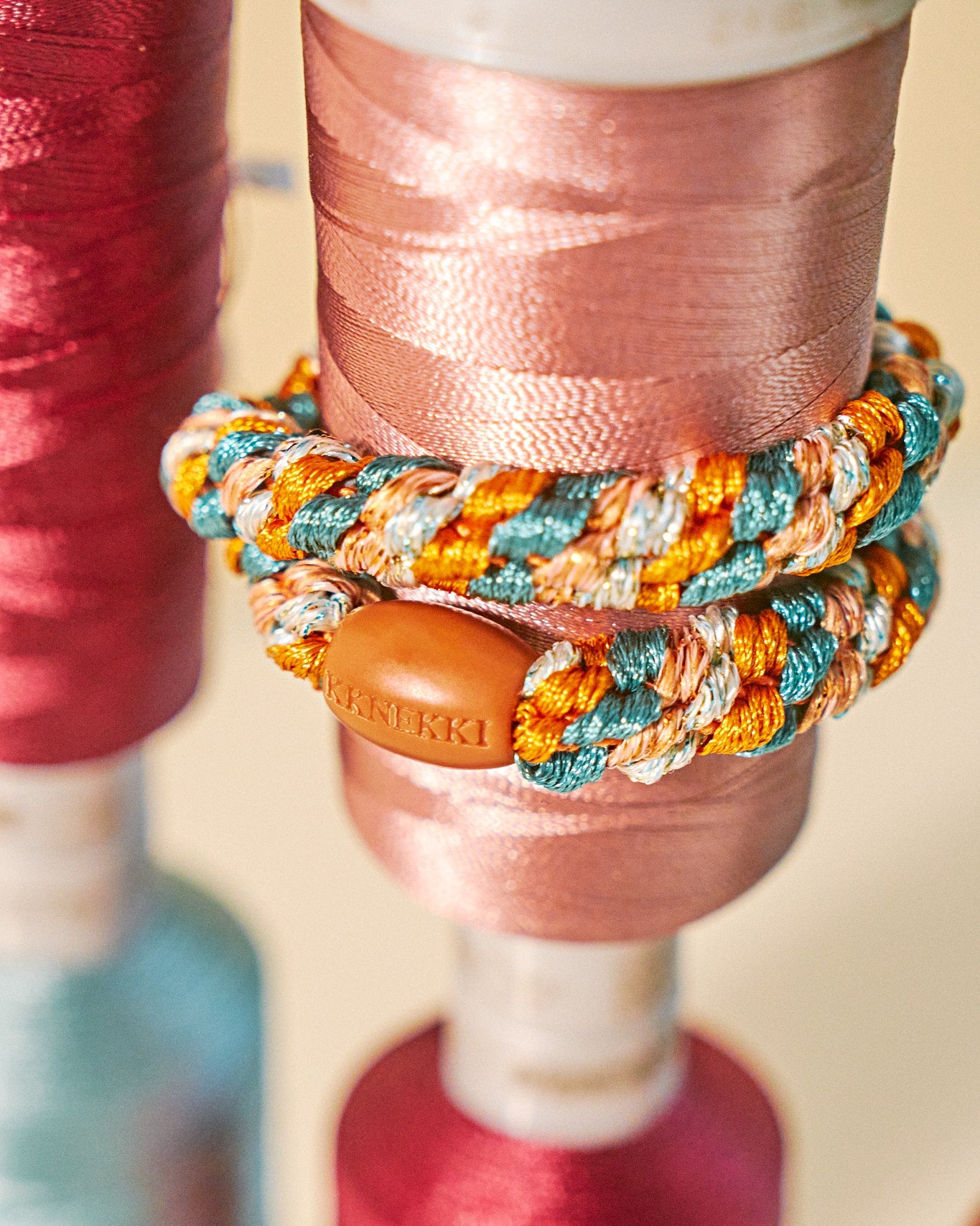 KKNEKKI hair tie Terracotta & Teal Mix – worn on the wrist