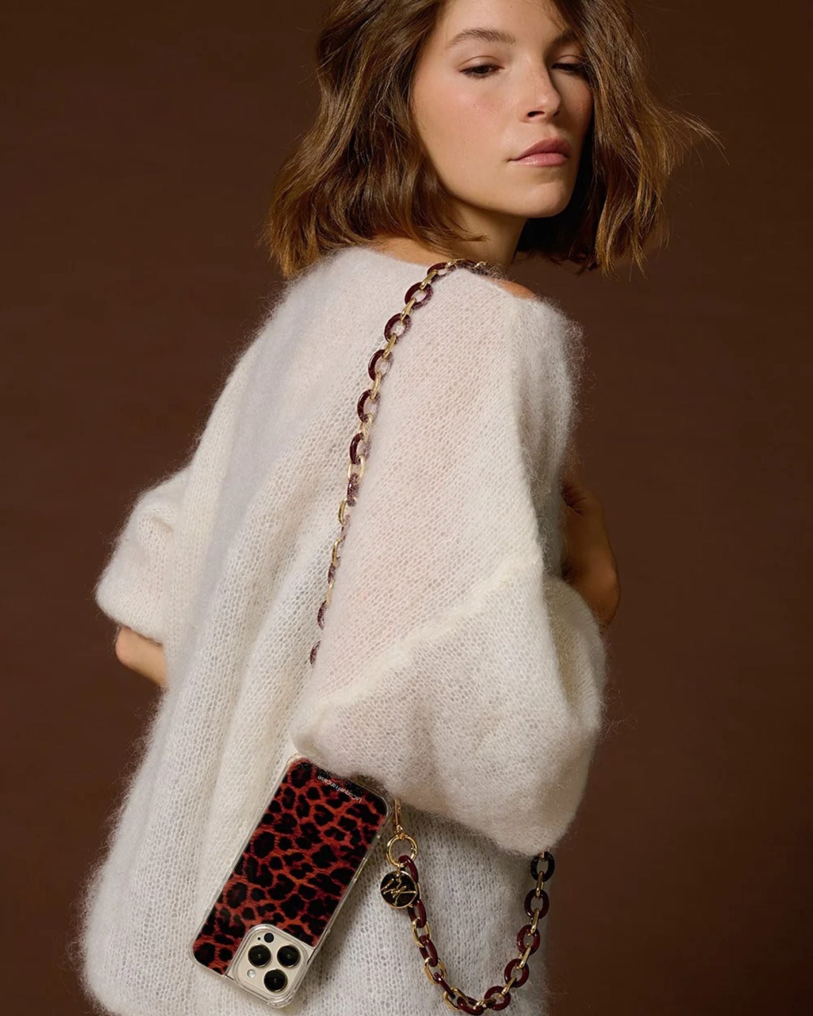 Woman styling the Classy Bordeaux phone chain crossbody with a minimalist look
